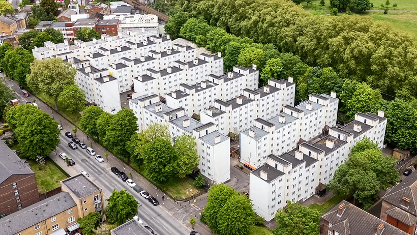 White apartment blocks among trees from above, drone property photography London