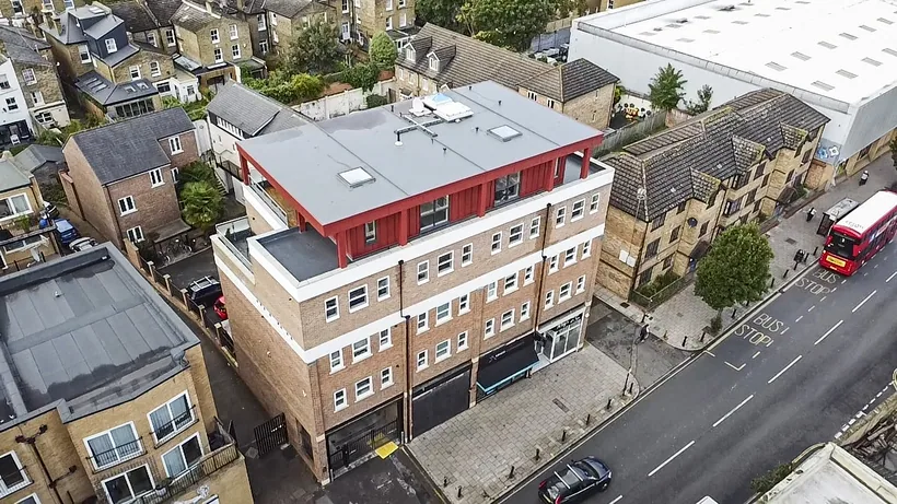 Corner apartment building on a main road from above, drone property photography London