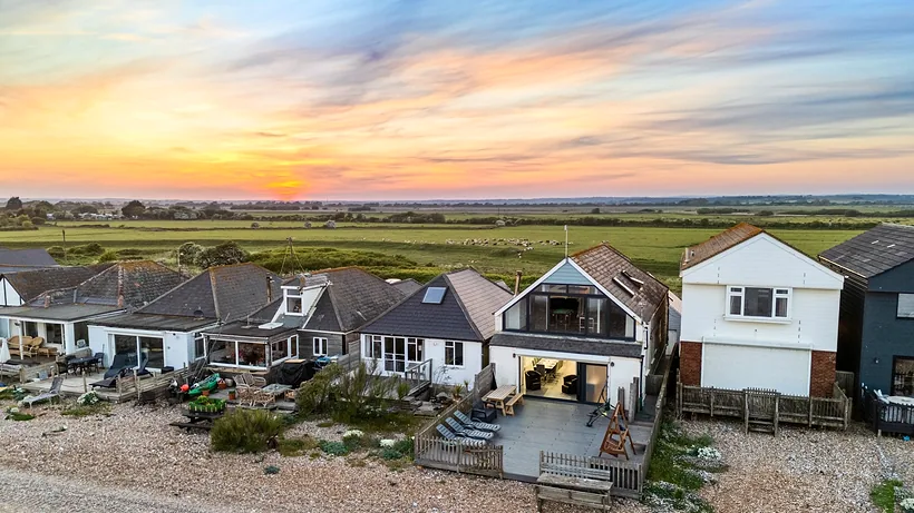 Beachfront houses under a sunset sky, drone property photography London