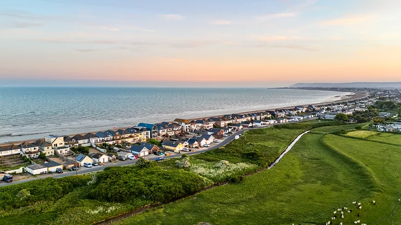 Coastal town and sea at dawn, drone property photography London