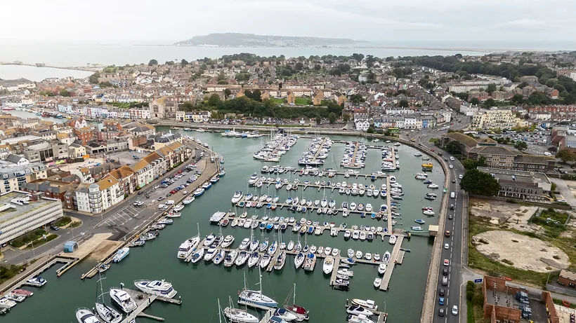 Drone: harbour marina through the old town, drone property photography London