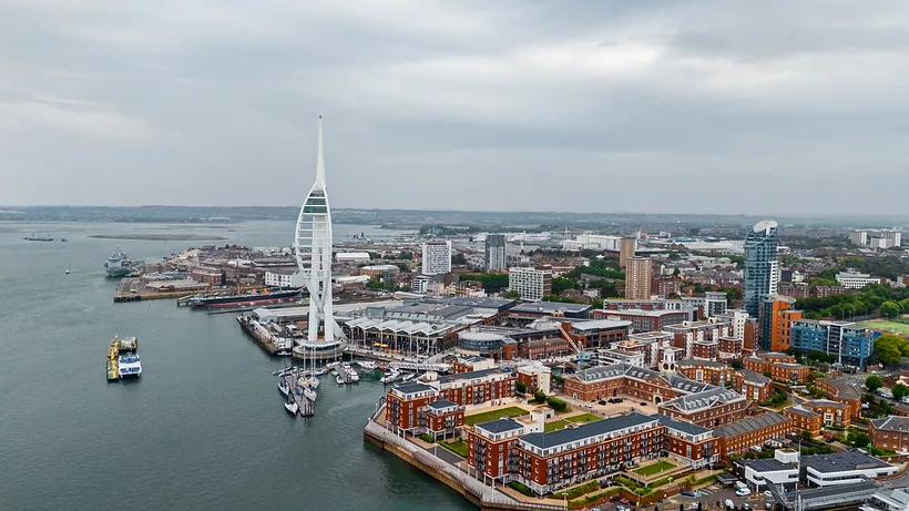 Drone: Spinnaker Tower with Gunwharf Quays waterfront, wide, drone property photography London
