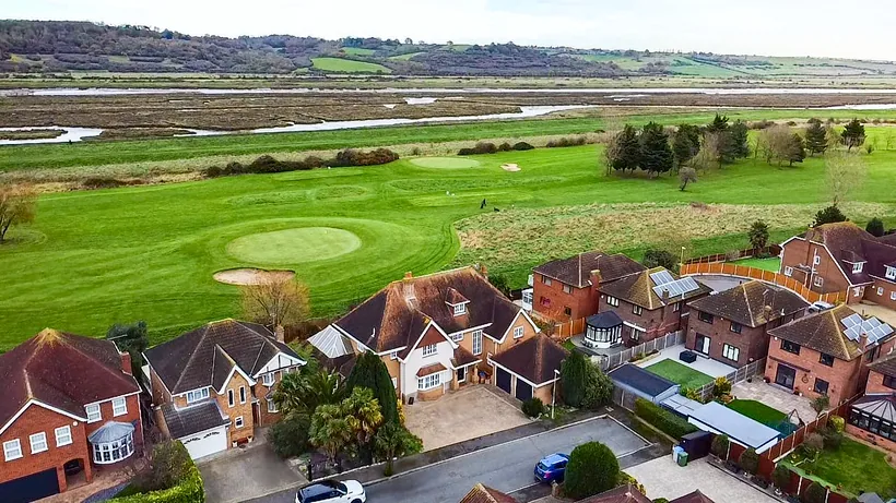 Drone over houses to golf course and river, drone property photography London