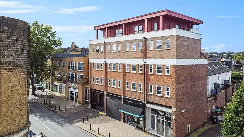 Drone view of the front of a brick-and-red block, drone property photography London