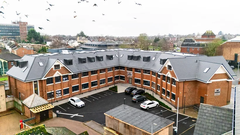 Drone over red-brick apartment development, drone property photography London