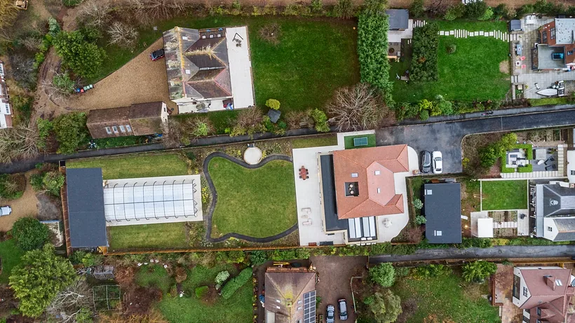 Top-down drone of house, pool roof and garden plots, drone property photography London