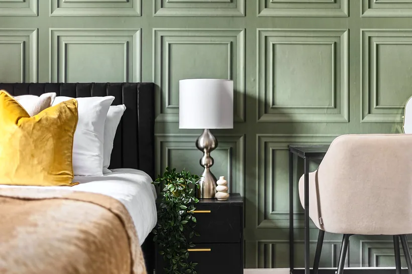 Sage panelled wall with mustard bedding, Airbnb photography London
