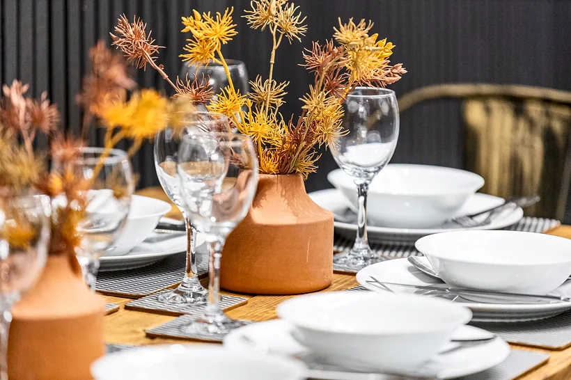 Orange-flower table setting, rich colour detail, Airbnb photography London