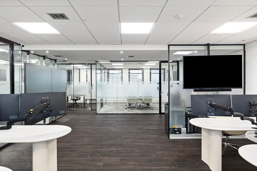 Open-plan office with glass meeting rooms, commercial photography London