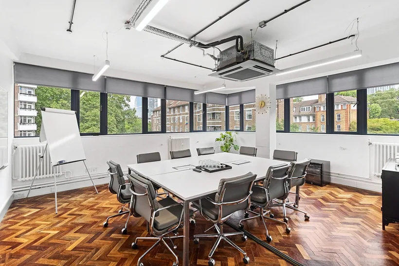 Boardroom table under exposed ducts, commercial photography London