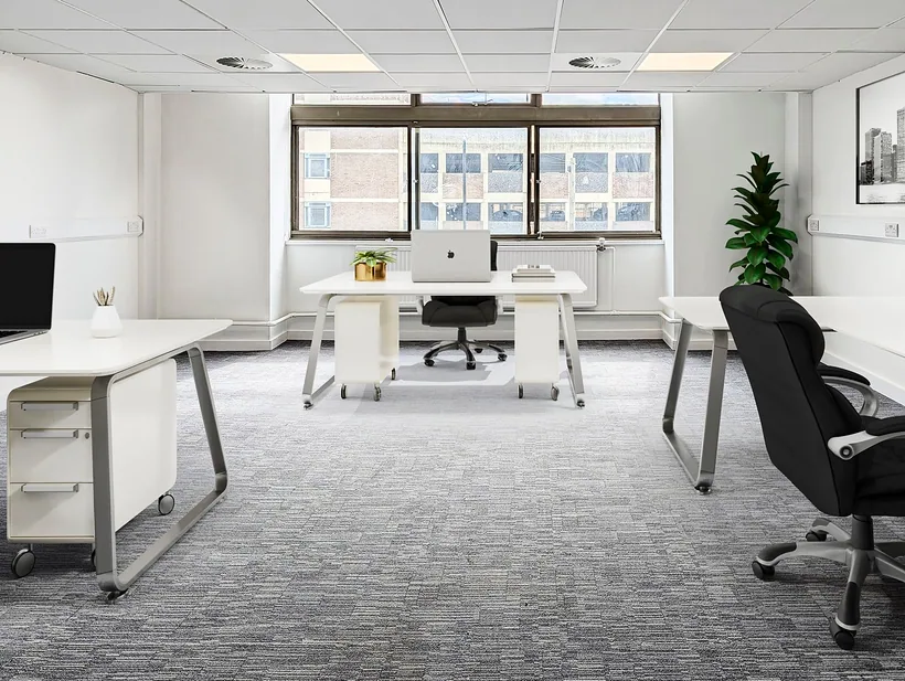 Office floor with white desks and grey carpet, commercial photography London