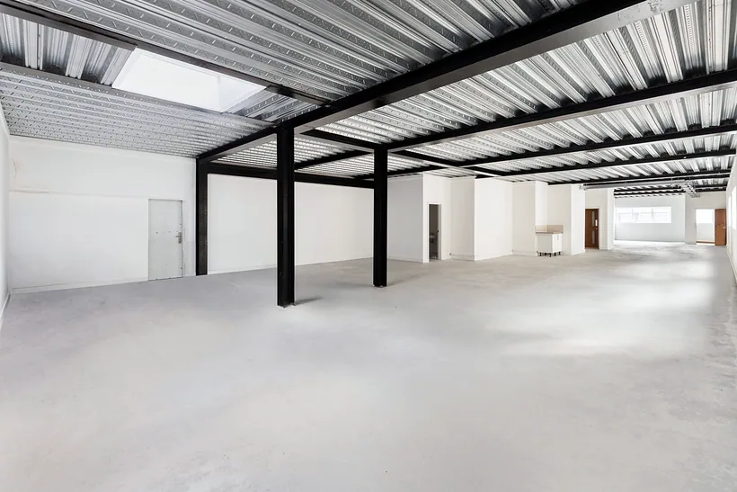 Empty ground-floor unit with steel beams, commercial photography London