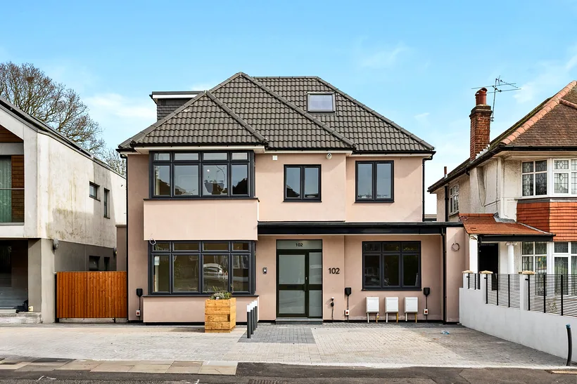 Rendered detached new-build house with a hipped roof, developer photography London