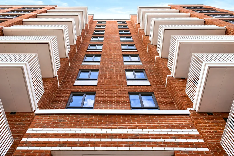 Brick facade of a new residential block, developer photography London