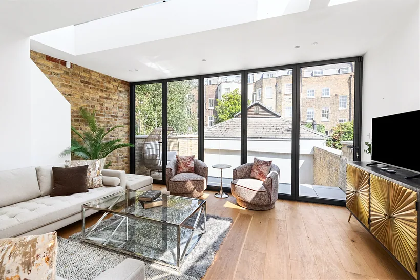 Living room with glazed doors onto a terrace, developer photography London