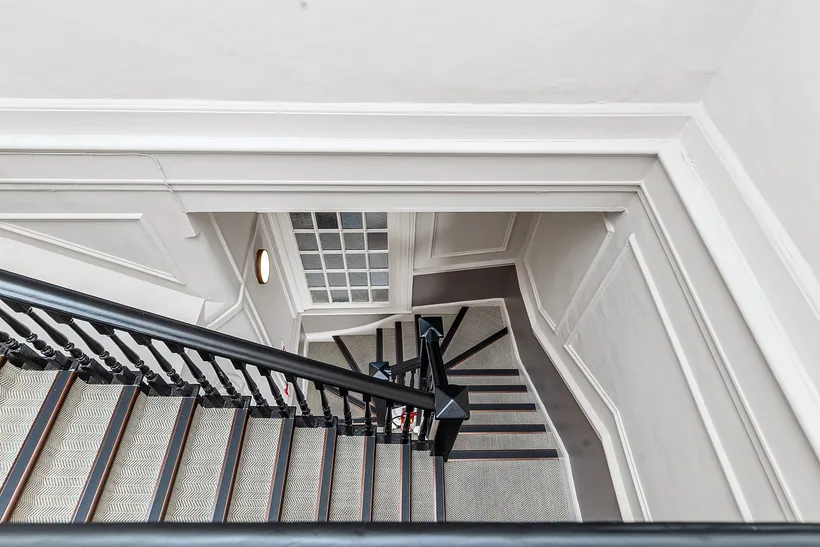 Stairwell with moulded cornicing, looking down, developer photography London