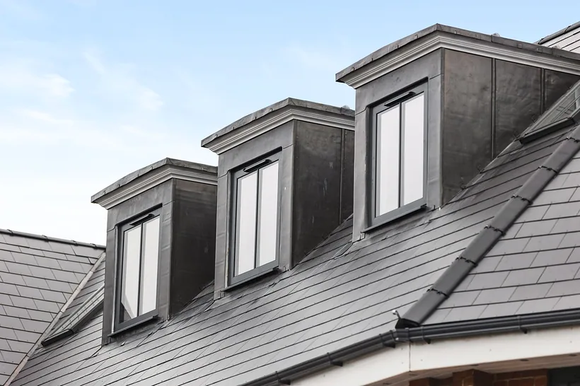 Crisp dormer roofline against blue sky, developer photography London