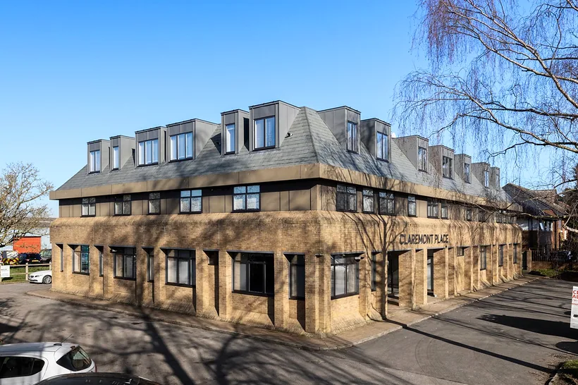 New-build block with mansard, blue sky, developer photography London