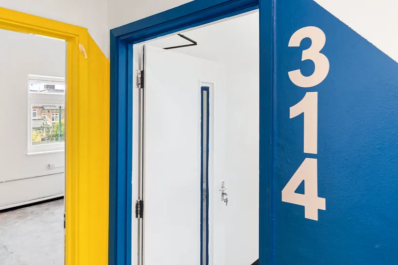 Graphic room-number door detail, colourful, developer photography London