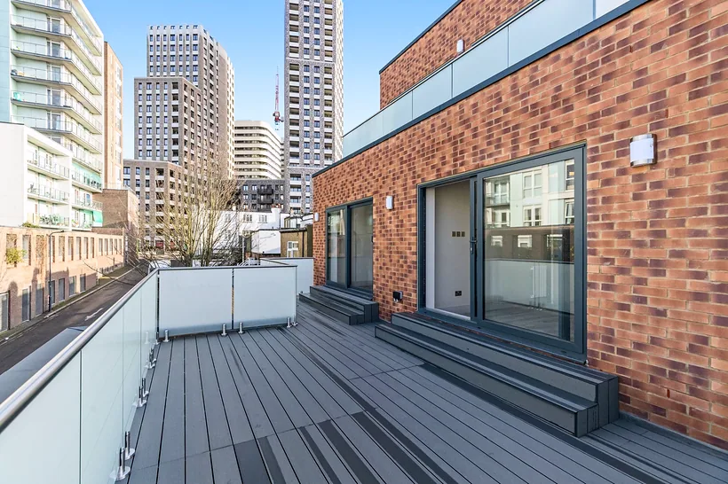 New-build roof terrace with city towers behind, developer photography London