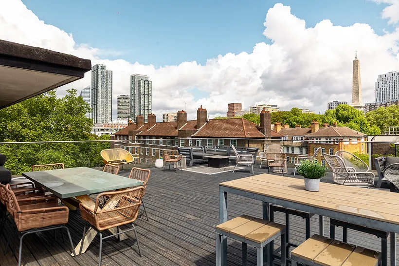 Office roof terrace with BT Tower and towers under big clouds, developer photography London