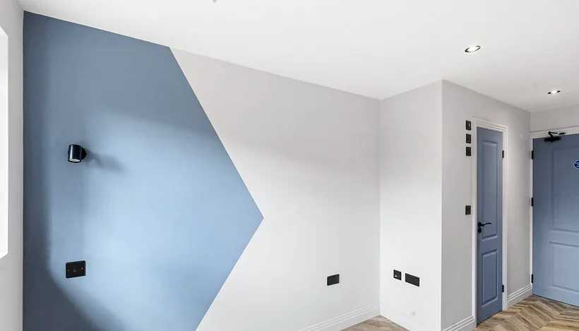 Graphic blue painted wall, HMO room refurb, developer photography London