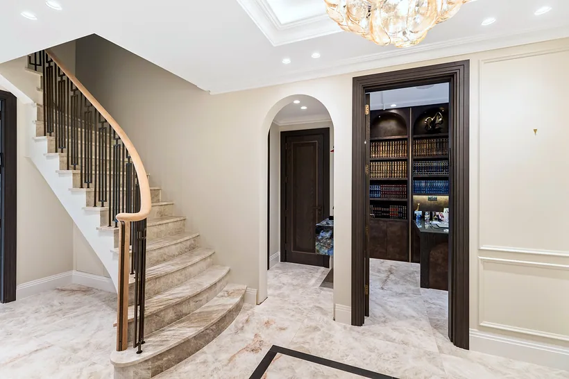 Sweeping curved marble staircase, luxury hallway, developer photography London