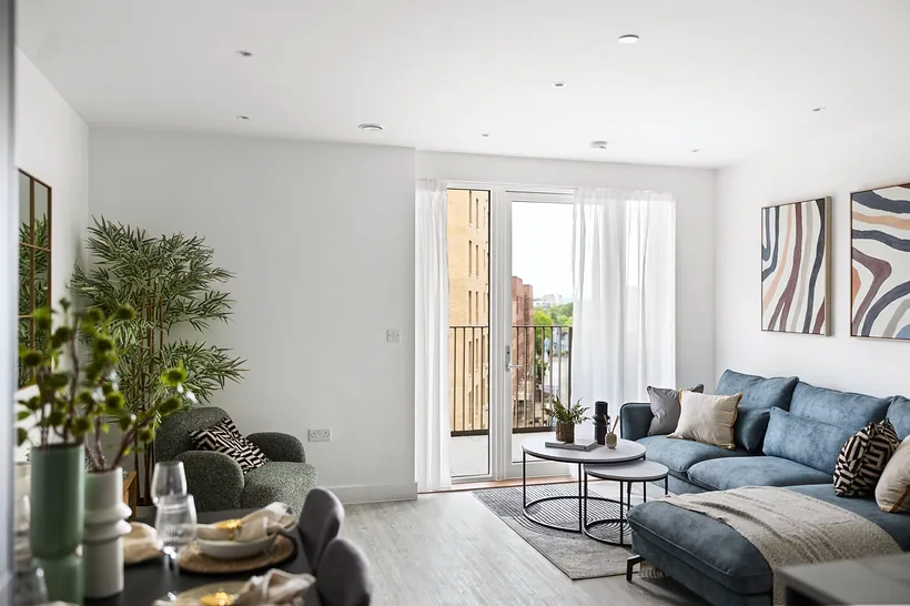 Teal sofa and plants with balcony doors, developer photography London