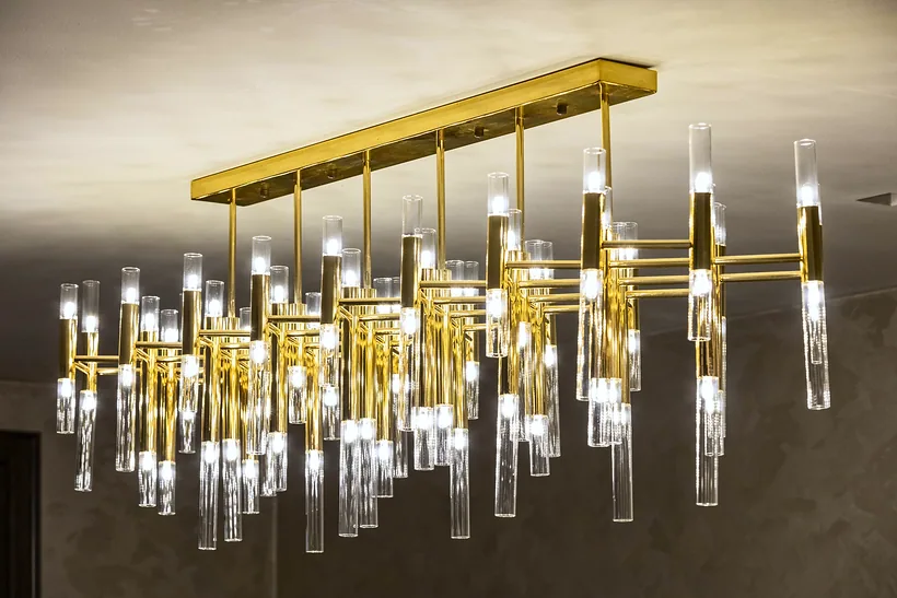 Brass and glass rod chandelier, interior photography London