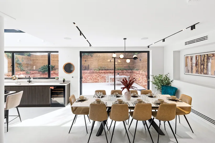 Open-plan dining kitchen opening onto the garden, interior photography London
