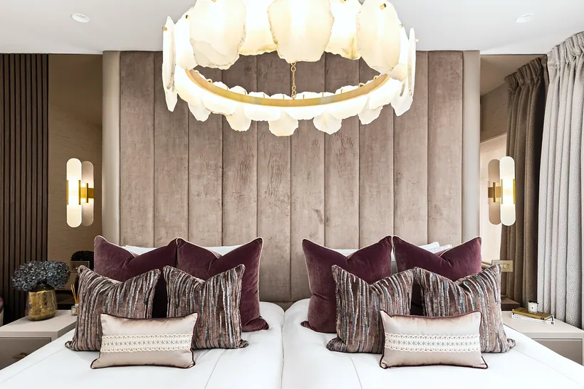 Bedroom with a panelled headboard and alabaster chandelier, interior photography London