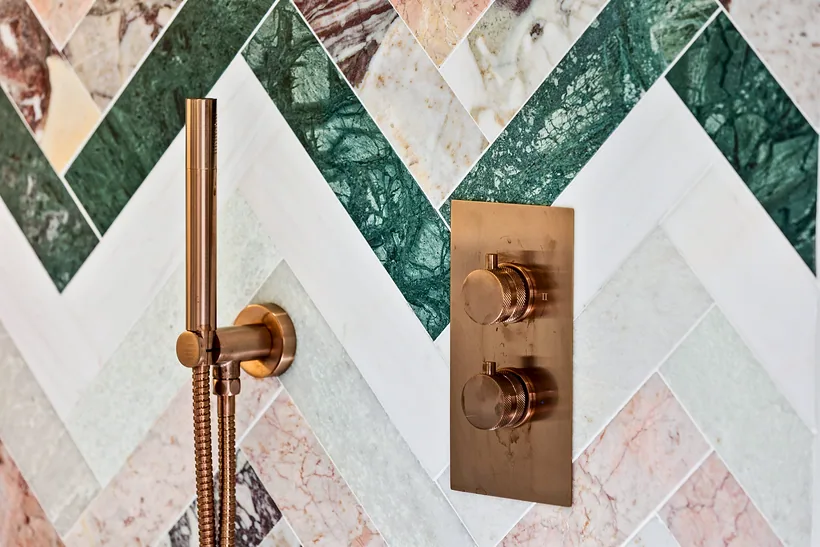 Herringbone marble tiles with copper shower, kitchen photography London