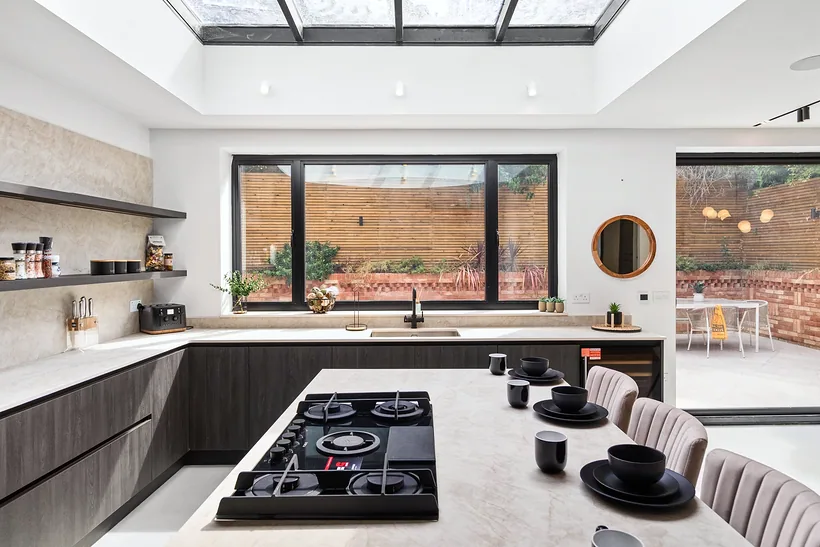 Kitchen island with a hob under a skylight, kitchen photography London
