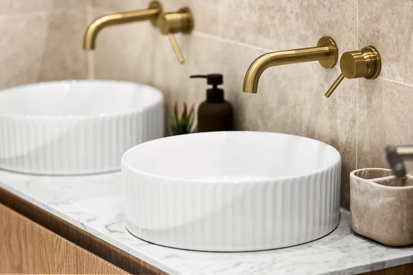 Fluted basins with brushed brass taps, interior photography London