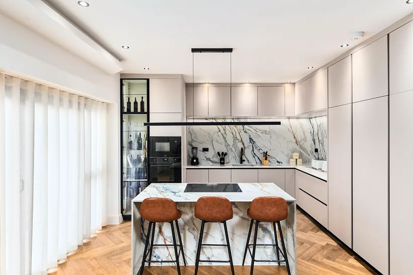 Marble splashback, tan stools, bright herringbone, kitchen photography London