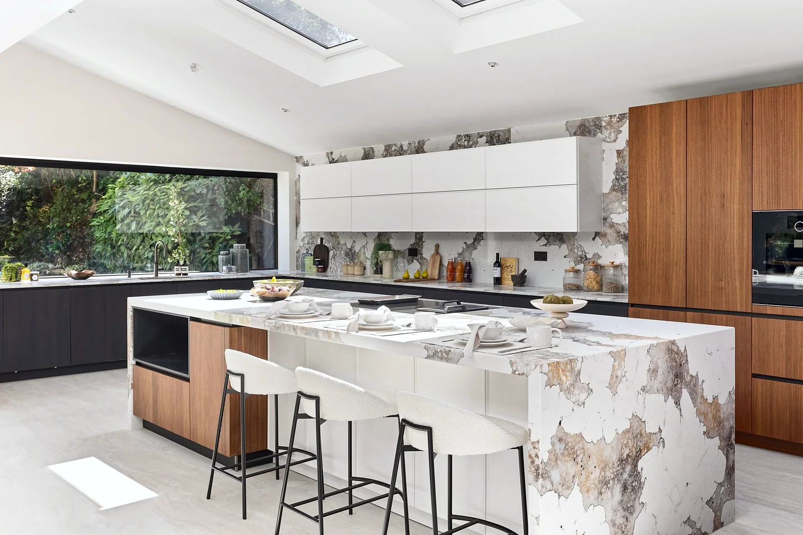 Marble waterfall island with garden window, kitchen photography London