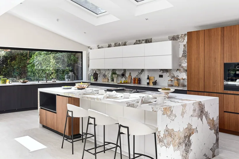 Marble waterfall island with garden window, kitchen photography London