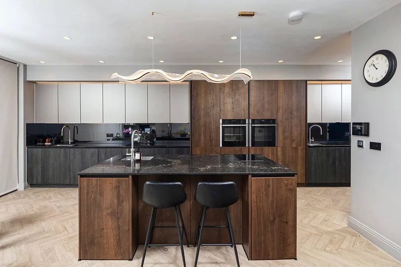 Walnut island with black worktop, kitchen photography London