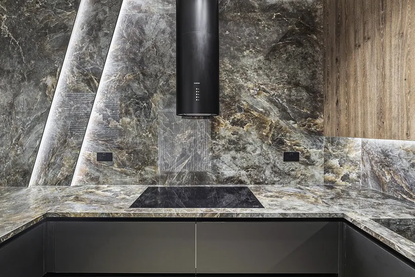 Dark marble kitchen with a black extractor hood, kitchen photography London