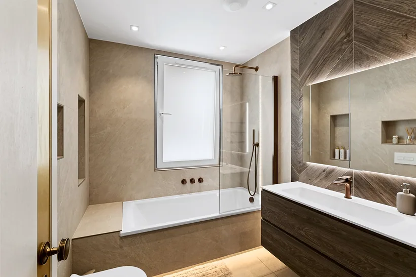 Bathroom with stone-effect tiles and a built-in bath, kitchen photography London
