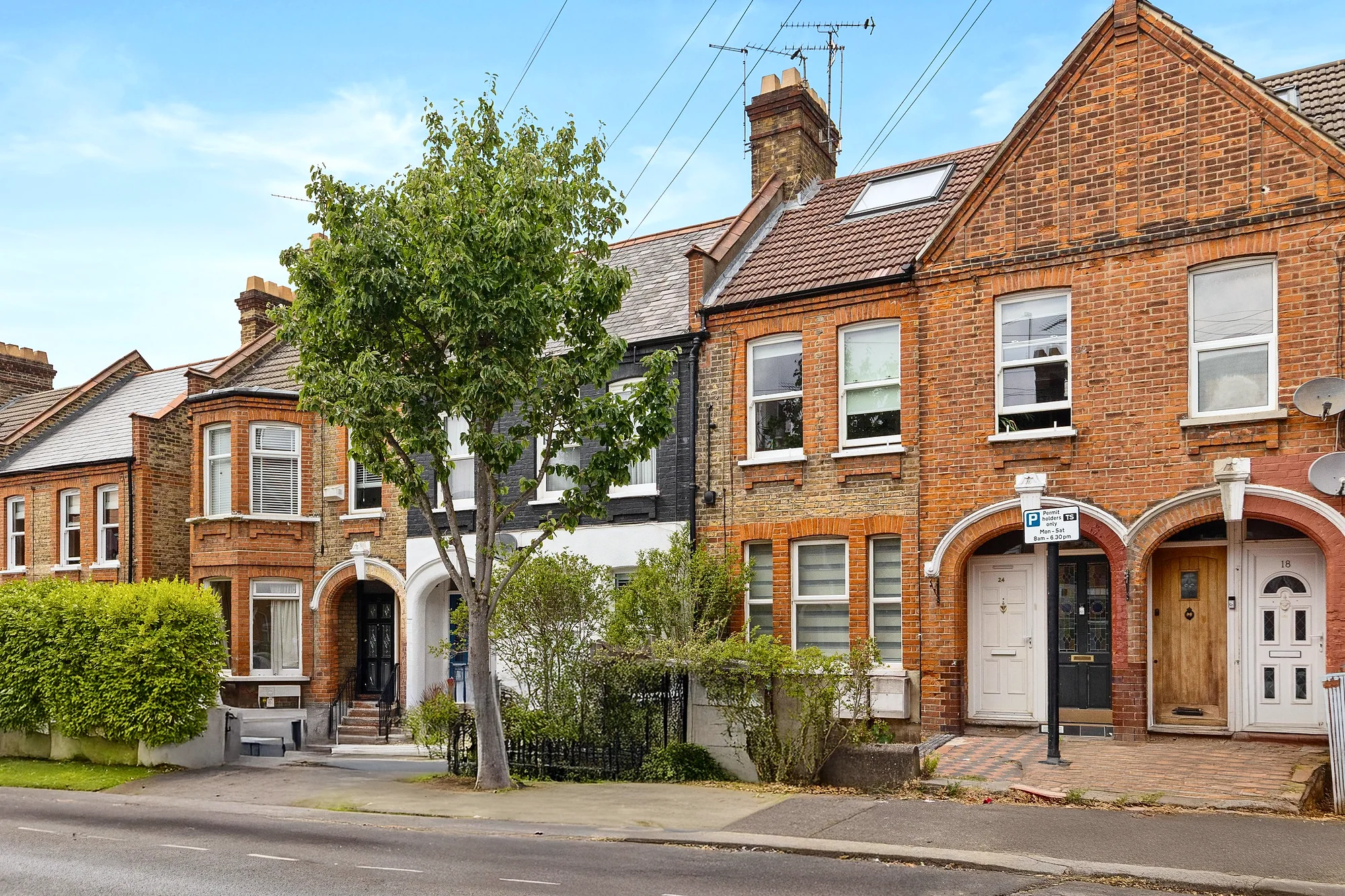 Red-brick Edwardian terrace on a sunny street, estate agent photography London