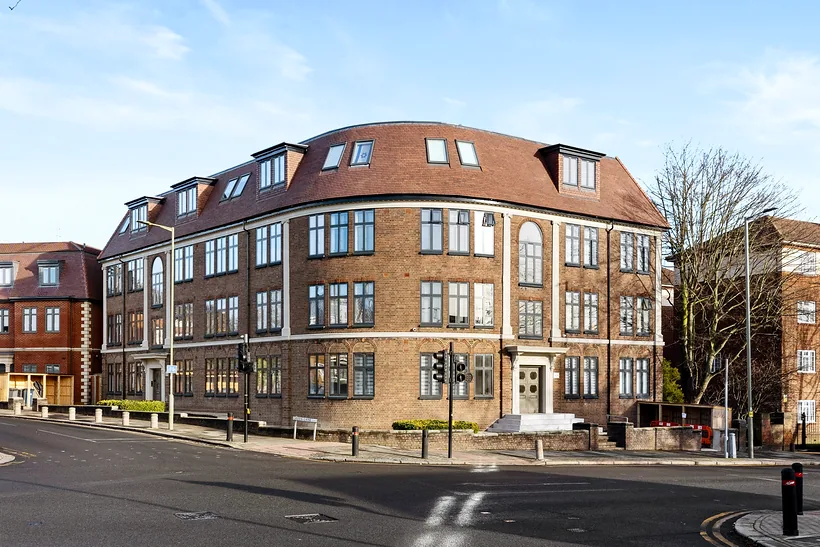 Corner apartment building under a blue sky, estate agent photography London