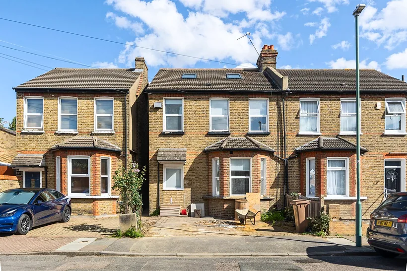 Pair of yellow-brick semis, dramatic sky, estate agent photography London