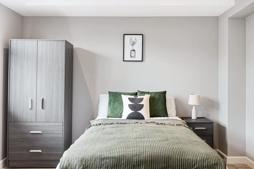 Sage bedding and art, calm styling, estate agent photography London